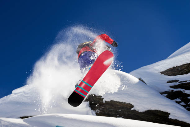 istock Extreme snowboarder making spectacular jump off a rock 693803314