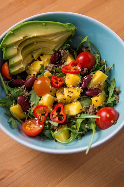 istock Mixed vegan vegetarian salad in a blue bowl 693810310