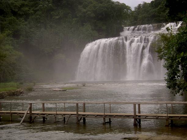 istock Wooden bridge in front of waterfalls 693816268