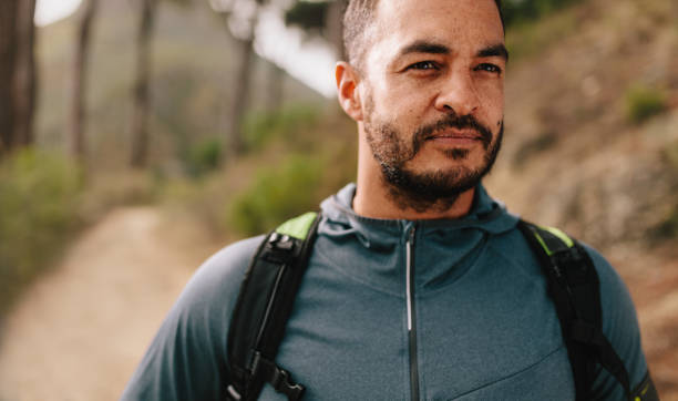 istock Fit young man standing on mountain trail 693827284