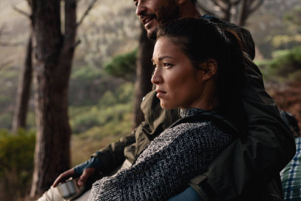 istock Young couple resting after hike 693829604