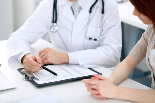 istock Doctor and patient are discussing something, just hands at the table 693829752