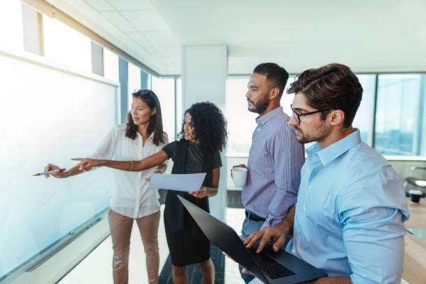 business associates making business plans at office. - pen business person men standing imagens e fotografias de stock