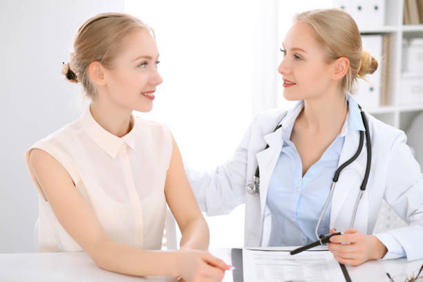 istock Doctor and  patient  sitting at the desk 693830218