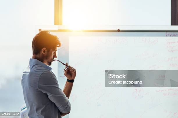 Entrepreneur Putting His Business Ideas On Whiteboard In Boardroom Stock Photo - Download Image Now