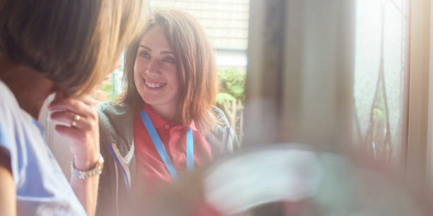 istock charity worker at the front door 693843970