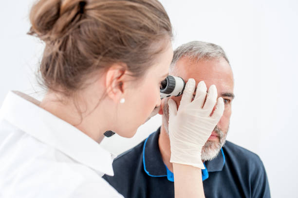 istock Dermatologist Inspecting Skin Moles on Patient Face 693844164