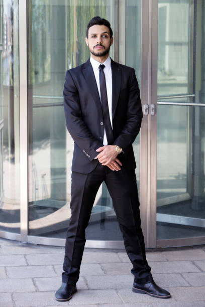 man standing in front of glass door portrait of handsome man standing in a suit and tie in front of glass door bouncer security staff stock pictures, royalty-free photos & images