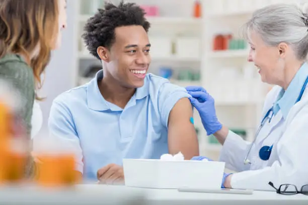 Photo of African American receives flu vaccine