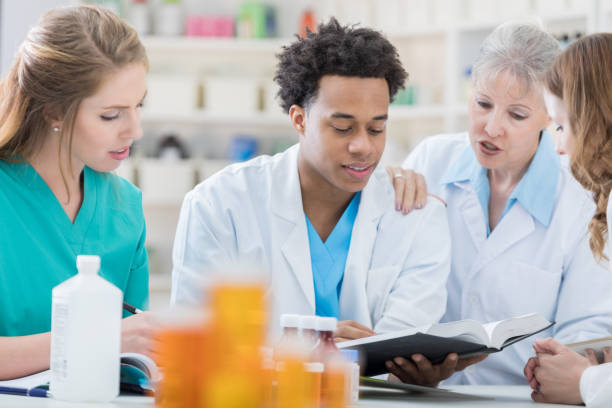 istock Pharmacist trains new pharmacy employees 693861194