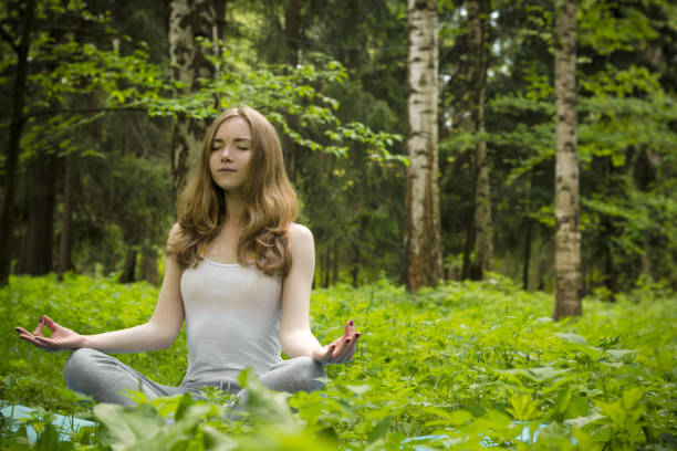 istock A girl is meditating in nature. 693863878