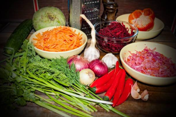 istock Raw ingredients for cooking vegetarian soup on a wooden table, top view. 693874100