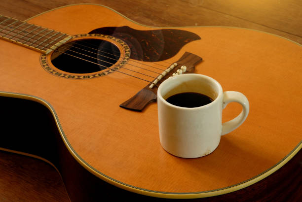 istock cup of coffee put on acoustic guitar 693878116