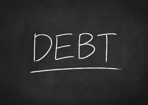 debt concept word on a chalkboard background
