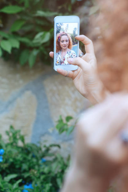 istock Young woman taking selfie 693893814