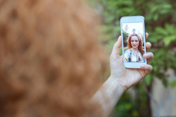 istock Young woman taking selfie 693893820