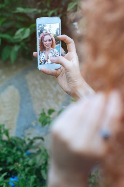 istock Young woman taking selfie 693893822