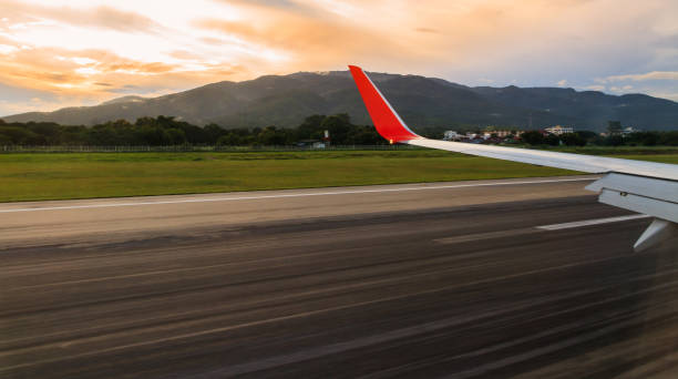 View of window from airplane on the runway at landing time.