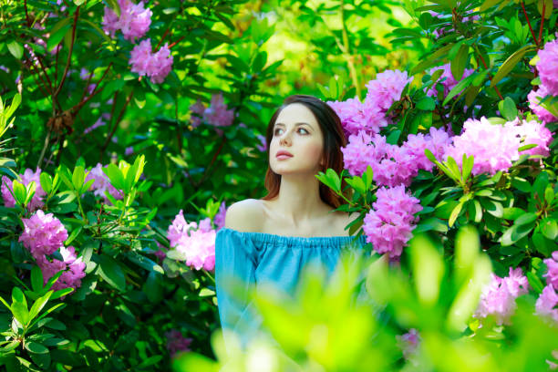 istock Red-haired woman in garden 693897008
