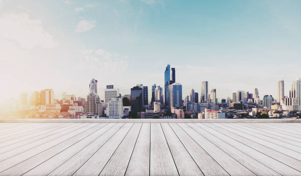 istock Panoramic city view in sunrise with wooden floor 693903754