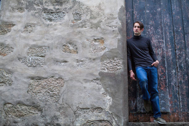 istock Young handsome man standing leaning on the wall. 693904002
