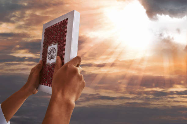 istock Muslim man hands holding koran 693916212