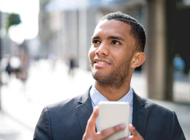 istock Thoughtful business man outdoors texting on his phone 693916552