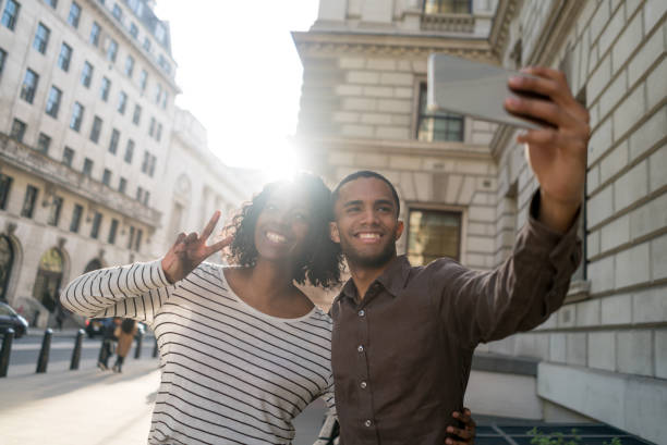 istock Happy young couple taking a selfie on the streets 693916632