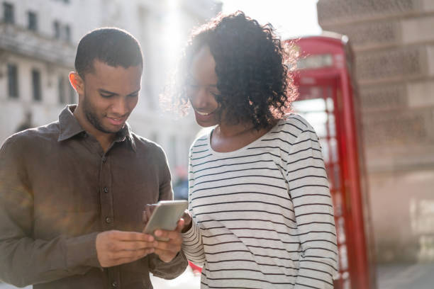 istock Couple sightseeing and using app on their cell phone 693916650