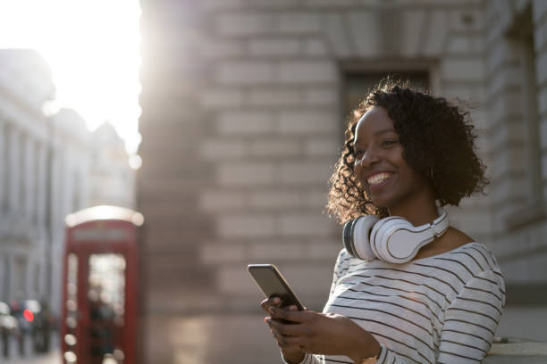 istock Happy woman texting on her cell phone 693916680