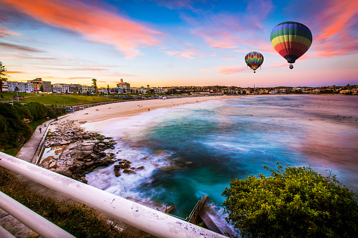 Two beautiful hot air balloons drifting though the sky.