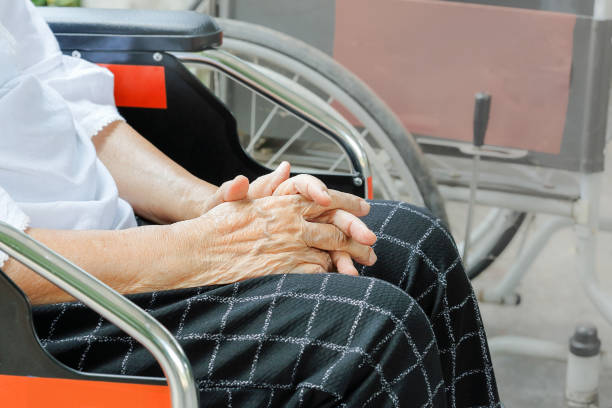 istock Elderly woman hand while waiting on wheelchair 693924730