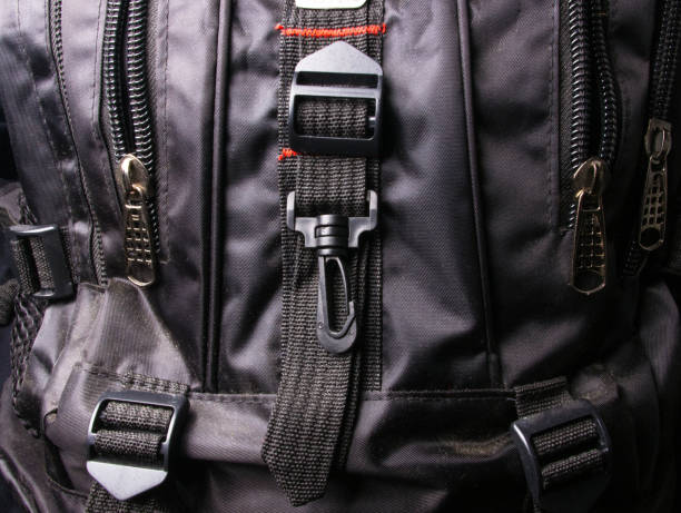 fittings and zips in the backpack closeup of buckles, clasps, zippers, pockets, fasteners, fittings and seams in the black backpack tineola stock pictures, royalty-free photos & images