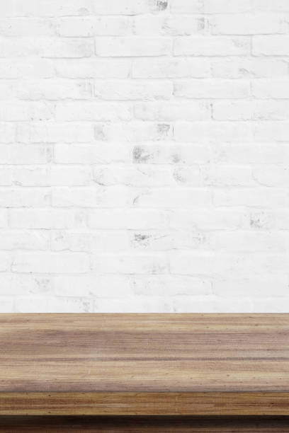 istock Empty wooden table over white brick wall  background, for product display montage 693931510