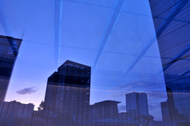 istock Windows with reflection of clouds and blue sky 693932114