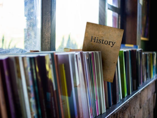 history on book cover on bookshelf, education concept - decades imagens e fotografias de stock