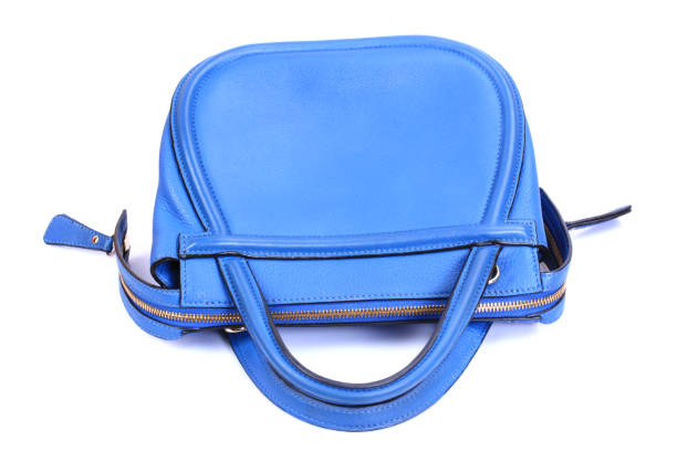istock Blue leather Women's handbag on white background 693934406