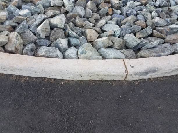 istock many grey and blue rocks and curb and asphalt 693936968