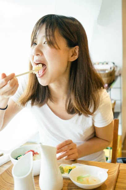 istock Young Japanese woman having lunch 693937034