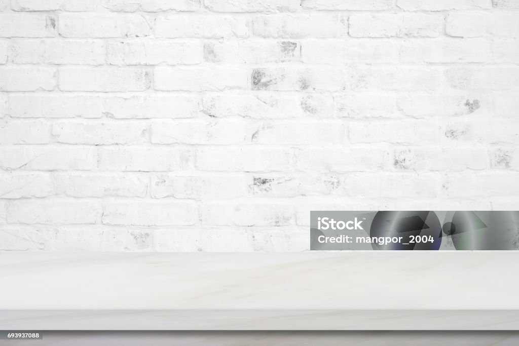 Empty white marble table over brick wall background, product display montage Backgrounds Stock Photo