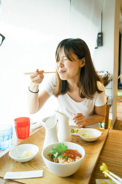 istock Young Japanese woman having lunch 693937402
