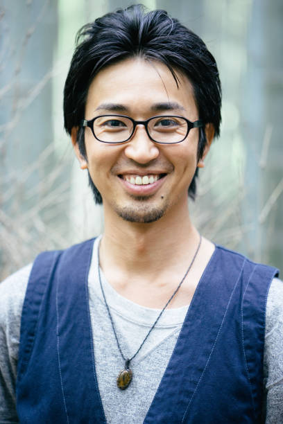 istock Young Japanese man portrayed outdoors in the nature 693937604