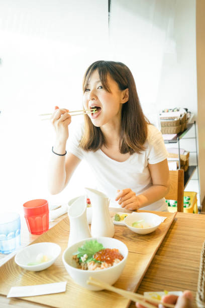 istock Young Japanese woman having lunch 693940282