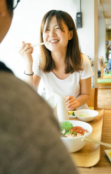 istock Young Japanese couple having lunch 693940700