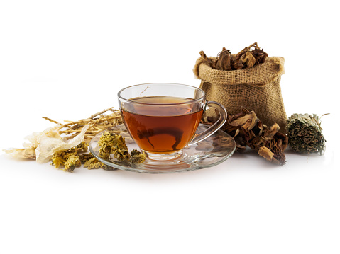 Herbal tea cup and dried herbal medicine on white background