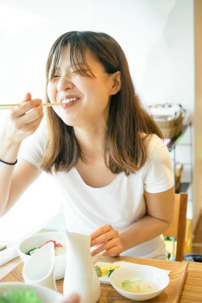 istock Young Japanese woman having lunch 693941138