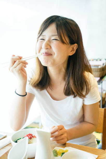 istock Young Japanese woman having lunch 693943262
