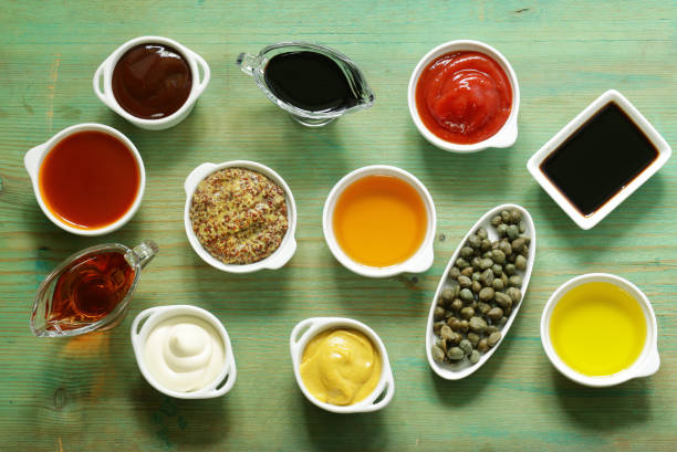 istock Different types of sauces and oils in bowls, top view 693964696