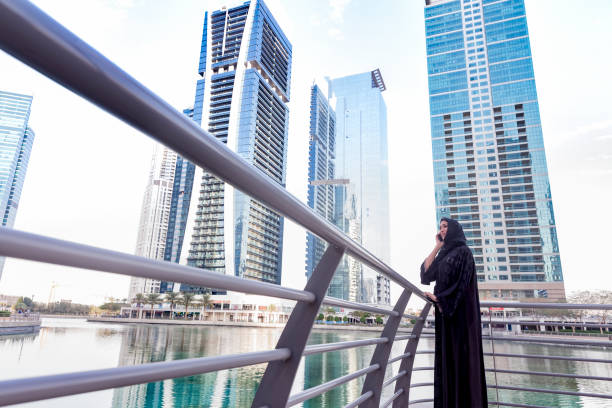 istock Modern Arab woman talking on her phone in a city 693975794
