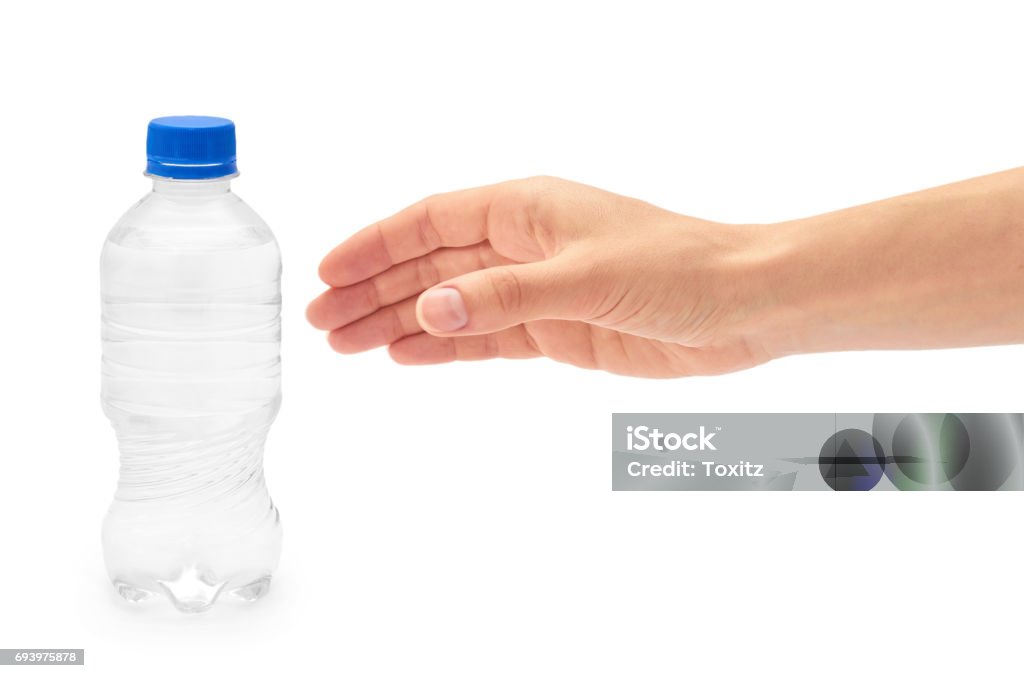 Female hand holds clean and fresh water packed in a plastic bottle. Isolated on white background Hand Stock Photo